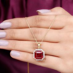 Product Details Elevate every look with the sparkling brilliance of our Classic Halo Pendant, which features a 10 mm asscher-cut created ruby elegantly set in prong setting surrounded by round petite moissanite creating a captivating halo frame, perfect for a striking look. Illuminate your fashion game with the charming allure of this ruby pendant comes with a delicate chain that offers both security and beauty. From casual wear to glamorous evening outfits, upgrade all your fits by wearing this Bridal Halo, Ruby Pendant, Halo Pendant, Asscher Cut, Delicate Chain, Evening Outfits, Round Shape, Timeless Pieces, Prong Setting