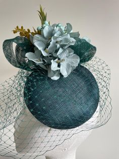 Item: Teal round button base sinamay fascinator with flowers and foliage, netting and sinamay loops.  Easy to wear, secured with an elastic.  Size: Approx. 20cms wide and 20cms high. Postage: The postage in this listing is regular post via Australia Post. Please allow approximately 7-10 days for postage at Australia Post (for metro areas) and more for regional areas.   Customise:  If you would like something added, deleted or changed, please send me a message to see if it is possible.  Postage: Green Fascinator, Sinamay Fascinator, Australia Post, Round Button, Teal Green, Wedding Basket, Fascinator, New Design, 10 Days