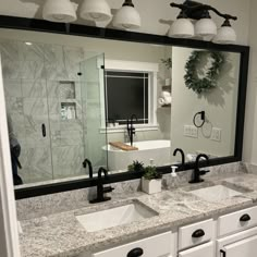 a bathroom with two sinks and a large mirror