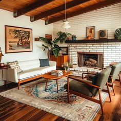 a living room filled with furniture and a fire place under a painting on the wall