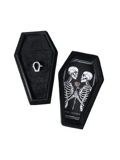 two skeleton rings in a black box on a white background, one with a skull and the other with a heart