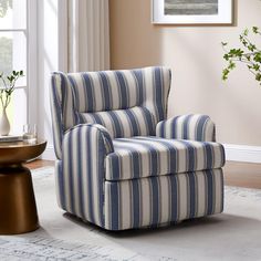 a blue and white striped chair sitting on top of a rug