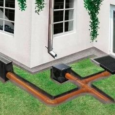 an image of a house with pipes going through the ground and in front of it