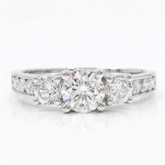 three stone diamond engagement ring with side stones on the band and sidestones in white gold