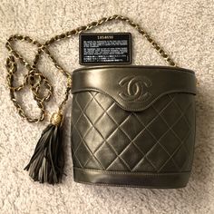 Vintage Chanel Binocular Bag. Unusual Metallic Olive Lambskin With Gold Tone Metal Accents And Chain. (Photo #1 Shows Color Most Accurately.) Certificate Of Authenticity. Can Be Used As A Crossbody Or Shoulder Bag. 6.25 Inches Tall. 7.00 Inches Tall. 3.75 Inches Deep At Widest Point. 4.50 Inch Tassel Attached To 2.00 Inch Chain. 20 Inch Shoulder Drop. Chanel Dust Bag Included. The Leather Has Softened And There Are Some Light Scratches As Shown In The Photos. Scuffing Around The Edges Of The Top Designer Bucket Bag With Detachable Handle As Gift, Luxury Bucket-shaped Evening Bag For Formal Occasions, Luxury Bucket Evening Bag For Formal Occasions, Luxury Bucket Style Evening Bag For Formal Occasions, Luxury Bucket Style Formal Evening Bag, High-end Bucket Bag For Evening, High-end Evening Bucket Shoulder Bag, High-end Evening Bucket Bag With Removable Pouch, Luxury Bucket Shoulder Bag Suitable For Gifts