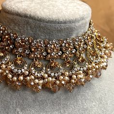 Choker only Stylish choker set adorned with sparkling golden and silver rhinestones and champagne beads, pearl detail  Measurements (Approx) Choker 1.5 inch  (Adjustable with sting) Ready to ship! Gold Jeweled Bridal Necklace For Party, Glamorous Gold Choker For Wedding, Glamorous Gold Bridal Necklace For Party, Gold Rhinestone Crystal Necklace For Celebration, Glamorous Gold Bridal Necklace For Festive Occasion, Gold Crystal Embellished Choker Necklace, Gold Rhinestone Choker For Party, Gold Bridal Choker Necklace For Party, Gold Bridal Necklace With Beads For Party