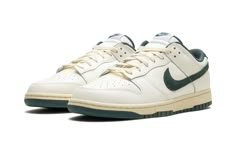 The Nike Dunk Low "Athletic Department - Deep Jungle" is a colorway of the retro basketball sneaker with a vintage college sports aesthetic.  The upper features a Sail leather construction with a Deep Jungle-colored suede Swoosh that matches the appearance of the heel tab with “Nike” embroidery.  Classic “Nike” detailing can be seen on the tongue.  More Deep Jungle accenting includes a green lining, and green rubber outsole underneath the rubber midsole.  A special “Nike Athletic Department” logo is found on each insole.  Release date: October 1, 2023 Vintage Nike Shoes Aesthetic, Nike Shoes Green, Vintage Nike Shoes, Green Nike Shoes, Nike Embroidery, Deep Jungle, Sneakers Box, Kobe Shoes, Retro Basketball