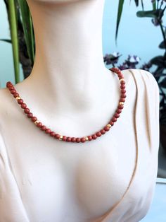 Red Jasper/garnet necklace with 6mm beads and zircons. MEASURES 35, 40, 45, 50, 55 and 60 cm. + 5cm extender.  There is the possibility of removing the extender in case you don't want it. Contact me to detail your request  💎M A T E R I A L S - 6mm Red Jasper semi-precious stones.   The stones are natural so they will never be the same as others. - Nickel-free and hypoallergenic brass fasteners. - Unbreakable steel thread for bead binding. 📦PACKAGING Very nice and original packaging, ready to give as a gift if desired. - Black aluminum can (measured according to the size of the jewel). - Organza bag, store card, discount VIP card, jewelry cleaning cloth    and some delicious sweets. - Padded bag for protection during transport. 📦 SHIPPING All products are sent with CERTIFIED Parcel of Co Red Jasper Necklace, Brass Fasteners, Red Jasper Stone, Pad Bag, Jasper Necklace, Garnet Necklace, Jasper Stone, Red Jasper, Elegant Gift