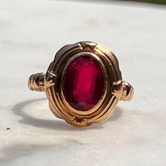 This classic and timeless garnet ring will be an everyday staple. Garnets are so lovely, and this setting augments the stone's beauty wonderfully. The oval garnet measures 6mm x 9mm in a bezel setting. The face sits 14.5 N-S and 13mm E-W, 4mm off the finger. Gorgeous shoulders. Garnet has some wear in accordance with age--there are a couple of scratches and wear along facets as seen under fluorescent light. In excellent condition otherwise!  Sized 5.25 and resizable. Shank narrows to 1.6mm.  Wei Classic Red Ruby Ring, Oval Cabochon, Classic Red Ruby Ring With Oval Cabochon, Classic Red Rings With Bezel Setting, Classic Red Ring With Bezel Setting, Classic Red Bezel Set Ring, Classic Garnet Rings With Bezel Setting, Vintage Oval Garnet Birthstone Ring, Classic Garnet Signet Ring For Anniversary, Vintage Oval Cabochon Ruby Ring With Polished Finish