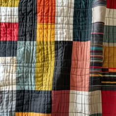 a multicolored patchwork quilt is shown in close up