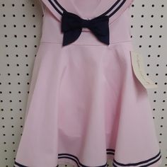 Cute Brand New With Tag Sophia Rose Sleeveless Pink Sailor Collar Dress. In Pink And Navy Blue....Has Separate Panties To Go Along With It. Zippered Back And Ties..........Size 18 Mos Measures: 8" Shoulder To Shoulder (Not Collar) .......9.5" Underarm To Underarm.......19" Shoulder To Bottom Of Dress. Has Nice Square Collar, Big Navy Bow, And Navy Stripe Trim Around Collar And Bottom Of Dress. Made Of 60% Cotton And 40% Polyester. Pink Cotton School Dress, Fitted Pink Dress For School, Pink Cotton Dress For School, Preppy Pink Dress For Spring, Preppy Pink Spring Dress, Pink Preppy Cotton Dress, Cute Pink School Dress, Preppy Pink School Dress, Preppy Pink Sleeveless Dress