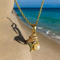 18K gold thick layered over High Quality Solid Stainless Steel. can be worn in water.  Our jewelry is made to last, anti-tarnish, higher durability than a regular gold-plated brass material, perfect for everyday wear. * Finish: 18K Gold * 18KGold Conch shell with white pearl * Featuring Adjustable Chain 16.5 inches to 18.5 inches. Length: 18.5 inch Material:Gold, tianiumsteel Pendant width: about 0.4 inch Pendant length: about 0.8 inch   all items are measured by handy, if has little size difference,  Please according to the real item size The sample picture is for display only. It can be personalized with any text and symbols. If you have any questions about this, please click on the question button next to the price and I will get right back to you. * All items are nicely packaged ready Gold Strand Jewelry For Gift, Elegant Gold Strand Jewelry, Gold Strand Necklace With Ocean-inspired Style, Gold Strand Necklace Ocean-inspired, Gold Ocean-inspired Strand Necklace, Ocean-inspired Gold Strand Necklace, Yellow Gold Shell Jewelry For Beach, Gold Strand Jewelry With Pearl Charm, Elegant Gold Strand Necklace