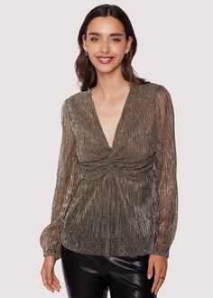 Experience the luxury of Le Mysterieux Top - a shimmering gold and silver chiffon top that adds a touch of sparkle to your wardrobe. With its long sleeves and V neckline, this piece creates a beautiful and eye-catching silhouette. Make a statement and look chic - pair Le Mysterieux Top with your favorite dark bottoms! WTKC02763 Imported 100% Polyester Model is 5 ft 11 inches; Bust: 32", Waist: 23.5", Hips: 35" and wearing a size Small Runs true to size Hand wash cold, Air dry to avoid shrinkage. Holiday 2024, High Hips, Cold Air, V Neckline, Chiffon Top, Look Chic, 11 Inches, Gold And Silver, Chiffon Tops