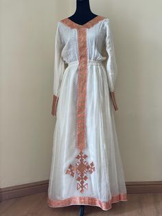 Beautiful habesha kemis with a intricate design trim. The dress is a hand made and machine embroidered.  *The dress is made to order, please include your size when you place your order.  *Please include your phone number with your address. It's required on the shipping form. Ceremonial Dresses With Embroidered Border For Festivals, Traditional Fitted Dress With Embroidered Border, Fitted Traditional Dress With Embroidered Border, Festival Dresses With Embroidered Border And Fitted Stretch, Fitted Habesha Kemis With Traditional Patterns For Ceremonies, Traditional Tunic Dress With Embroidered Border, Traditional Maxi Dress With Embroidered Border, Folk Style Dresses With Resham Embroidery For Ceremonies, Folk Dresses With Resham Embroidery For Traditional Ceremonies