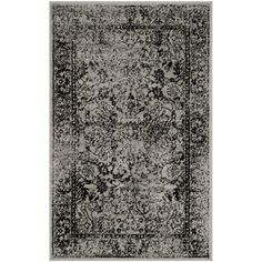 a black and white rug with an ornate design