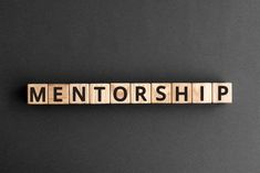 the word mentorship spelled with wooden letters on a black background photo - free stock photo