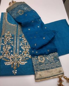 Item Overview ATHARVA Hand Embroidered Salwar Kameez inNavy Blue w/Embroidered Neck/Banarsi Silk Dupatta/Gota Patti/Custom Stitching/Wedding/Latkans/CH Dno. CH Fabric: * Shirt: Chanderi Silk - Navy Blue - 2.5 Mts, with Beautiful Embroidery Neck * Dupatta: Banarsi Silk Dupatta. (Motifs may wary) * Salwar: Santoon Silk - 2.5 Mts. Excusive Hand Embroidered Party Wear Punjabi Suit. Customization: * Fabrics: Designs Can be made in different Fabrics. * Stitching Available Care: * Dry Clean/ Avoid dire Festive Blue Unstitched Sharara, Blue Unstitched Sharara For Festive Occasions, Blue Anarkali Set With Zari Work For Transitional Season, Transitional Blue Anarkali Set With Zari Work, Blue Bollywood Sharara For Transitional Season, Blue Sharara With Zari Work For Transitional Season, Transitional Blue Chanderi Salwar Kameez, Festive Blue Chanderi Anarkali Set, Blue Raw Silk Anarkali Set For Diwali