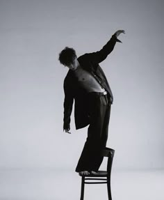 a man standing on top of a chair