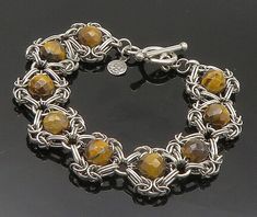 "925 Sterling Silver - Vintage Faceted Tigers Eye Beaded Chain Bracelet - BT8269  925 Sterling Silver - Vintage Faceted Tigers Eye Beaded Chain Bracelet - BT8269  Jewelry Type:         Bracelet  Metal Type:            925 Silver   Metal Size:             7.5\" Length  .75\" Height   Stone Type:            Tigers Eye  Condition:              N/A  Jewelry Weight:     29.7 Grams  PLEASE NOTE: THIS ITEM IS PRE-OWNED. ALTHOUGH MOST ITEMS ARE IN VERY GOOD CONDITION, SOME MAY NEED CLEANING AND/OR MINOR REPAIRS. WE MAKE A VERY STRONG EFFORT TO UPLOAD CLEAR PICTURES. PLEASE INSPECT ALL PICTURES AND ASK ALL QUESTIONS YOU MAY HAVE PRIOR TO MAKING A PURCHASE. NOT ALL STONES ARE GENUINE, SOME ARE ENHANCED OR CREATED." Sterling Silver Jewelry With Round Beads Chain, Silver Beaded Chain Bracelets For Jewelry Making, Silver Beaded Round Chain Bracelet, Beaded Silver Chain Bracelet, Beaded Chain Bracelet, Chainmaille Bracelet, Clear Pictures, Bracelet Metal, Tiger Eye Beads