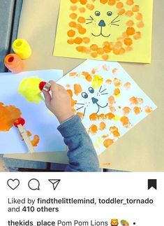 a child is painting on paper with watercolors and then using glue to make lion faces