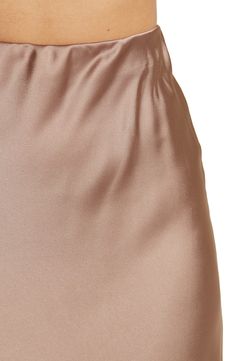 Elevate your wardrobe with this pull-on bias satin midi skirt for elegant, feminine style. 31" length (size S) Elasticized waist Pull-on style Satin construction 97% polyester, 3% spandex Machine wash cold, line dry Made in USA Model’s stats for sizing: 5’10” height, 34” bust, 27” waist, 35” hips. Model is wearing size S. Silk Mini Skirt For Evening, Elegant Stretch Silk Skirt, Elegant Satin Bottoms With Elastic Waistband, Silk Bottoms With Satin Finish For Spring, Spring Silk Bottoms With Satin Finish, Satin Pencil Skirt For Summer, Elegant Satin Finish Bottoms For Spring, Silk Skirt With Elastic Waistband And Relaxed Fit, Elegant Knee-length Skirt With Elastic Waistband