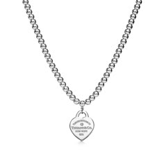 Inspired by a key ring we debuted in 1969, the Return to Tiffany® collection is famous for its signature motif. This sterling silver bead necklace features our iconic heart tag at its center, set with a round brilliant diamond. Wear this standout silhouette on its own or mix with your favorite necklaces for a look that’s all your own. Sterling silver with a round brilliant diamond; 16" long; Motif size, small; Lobster closure; Beads, 4 mm; Carat weight .01 | Return to Tiffany® Heart Tag Bead Nec Tiffany And Co Silver Jewelry, Return To Tiffany, Tiffany Necklace, Heart Tag, Silver Bead Necklace, Jewelry Essentials, Girly Accessories, Stacked Jewelry, Tiffany Heart