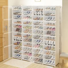 a white shoe rack filled with lots of shoes