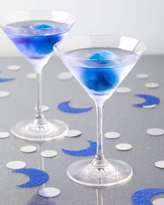 two martini glasses with blue liquid in them