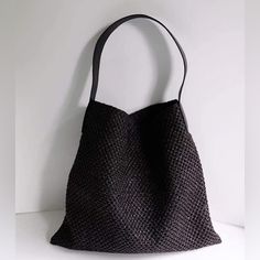 a black handbag hanging on the wall