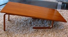 a wooden table sitting on top of a carpeted floor