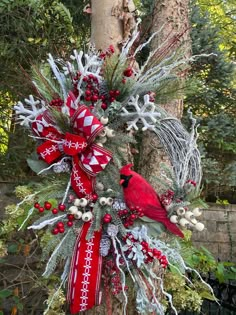 a christmas wreath with a cardinal on it