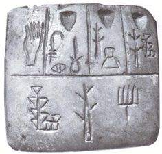 an ancient object with writing and symbols on it