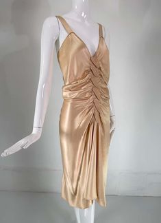 For Sale on 1stDibs - John Galliano, old Hollywood glamourous gold satin evening dress with a plunge V neckline and chiffon woven shirred center front, The back features a row Elegant Gold V-neck Evening Dress, Gold V-neck Evening Dress For Gala, Ruched V-neck Evening Dress For Night Out, Ruched V-neck Satin Dress For Formal Occasions, Gold Satin Dress For Prom Season, Gold V-neck Evening Dress For Summer, V-neck Evening Dress For Prom Season Dinner, Glamorous Ruched Evening Dress For Dinner, Gold Ruched Draped Dress