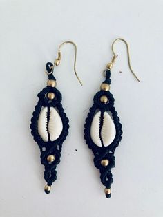 Our macrame summer earrings are made with a natural cowrie shell beautifully set in macrame and embellished with tiny pieces of brass as ornaments. A perfect accessory for all our bohemian looks, it will evoke the sea and the holiday atmosphere even long after returning to the city. Keep a piece of nature always with you! Look for more beach jewellery in our assortment. Keep a piece of nature always with you! Traditional Summer Jewelry For Vacation, Traditional Summer Vacation Jewelry, Bohemian Cowrie Shell Dangle Jewelry, Traditional Macrame Earrings, Adjustable Traditional Earrings For Beach, Bohemian Adjustable Cowrie Shell Earrings, Summer Macrame Dangle Jewelry, Beach Brass Drop Earrings, Summer Festival Macrame Jewelry