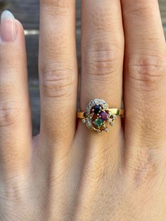 Total Weight: 3.5 grams Size: 6.5 Band Width: 2.1-2.5mm  Spinel: 2.6mm Diamonds: 1.1mm Emerald: 2.9mm Condition: In great condition showing little wear with no damage.  All gold has been thoroughly checked with an Olympus XRF spectrometer. It is guaranteed 14k gold.  All our jewelry is properly washed and disinfected to ensure customers get clean items with every order.  Returns accepted but may be subjected to a restock fee.  Please message with any questions:) Multicolor Oval Heirloom Ring, Heirloom Style Multicolor Oval Rings, Heirloom Multicolor Oval Rings, Gold Oval Multi-stone Birthstone Ring, Oval Multi-stone Yellow Gold Birthstone Ring, Yellow Gold Diamond Cluster Ring With Multi-stone, Heirloom Yellow Gold Cluster Ring With Multi-stone, Collectible 14k Gold Multi-stone Rings, Collectible Multi-stone 14k Gold Rings