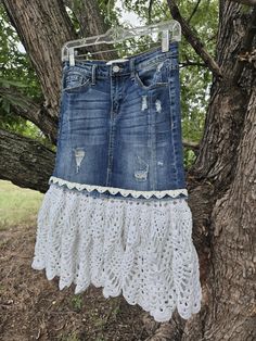 a denim skirt hanging from a tree