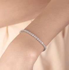 Tennis Bracelet | S925 Sterling Silver, Simulated Diamond Bracelet | Gifted Jewelry 𝐃𝐞𝐬𝐜𝐫𝐢𝐩𝐭𝐢𝐨𝐧 ✧ 𝐏𝐫𝐞𝐦𝐢𝐮𝐦 𝐐𝐮𝐚𝐥𝐢𝐭𝐲 𝐌𝐚𝐭𝐞𝐫𝐢𝐚𝐥: Crafted from high-quality S925 sterling silver for lasting shine and durability. ✧ 𝐂𝐮𝐛𝐢𝐜 𝐙𝐢𝐫𝐜𝐨𝐧𝐢𝐚 𝐒𝐭𝐨𝐧𝐞𝐬: Each CZ stone is carefully selected to mimic the brilliance of real diamonds, providing an ethical and affordable luxury. ✧ 𝐂𝐥𝐚𝐬𝐬𝐢𝐜 𝐒𝐭𝐲𝐥𝐞: The iconic tennis bracelet design ensures it complements any outfit. ✧ 𝐏𝐞𝐫𝐟𝐞𝐜𝐭 𝐆𝐢𝐟𝐭: Elegantly packaged, making it an ideal gift for any occasion. Elevate your style with our Tennis Bracelet, where sophistication meets affordability. 𝐒𝐩𝐞𝐜𝐢𝐟𝐢𝐜𝐚𝐭𝐢𝐨𝐧𝐬 − 𝐌𝐞𝐭𝐚𝐥: S925 Sterling Silver − 𝐅𝐢𝐧𝐢𝐬𝐡: Silver, Gold, Rose Gold − 𝐒𝐢𝐳𝐞: 6in, 7 Tennis Bracelet Silver, Bracelet Tennis, Bracelets Design, Wedding Jewelry Bracelets, Bracelet Design, Affordable Luxury, Wedding Bracelet, Tennis Bracelet, Cz Stone