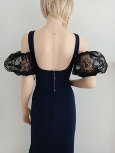 the back of a woman's dress with black lace sleeves and open shoulderline