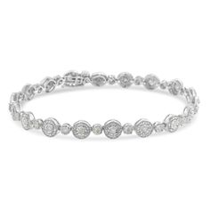 Round cut, miracle set diamonds twinkle in this simple and sleek bracelet. Each diamond is set at the center of a beaded circle that when linked together give life to the bracelet design. 1 1/3ct TDW of promo quality diamonds sparkle in this sterling silver jewelry piece. Promo quality diamonds are on the lowest of diamond color and quality scale. Round-cut, promo quality diamonds are milky and cloudy in nature. They have asymmetrical ball shape and are filled with inclusions. White Diamond Bracelet With Accents, Fine Jewelry Bracelet In Diamond White, Fine Jewelry Diamond White Round Bracelets, Round Diamond Bracelet With Halo Setting, Timeless Round Diamond Jubilee Bracelet, Diamond White Bracelets With Diamond Accents, Round Diamond White Bracelets With Diamond Accents, Diamond Bracelet With Halo Setting, Classic Bracelets With Halo Setting For Anniversary