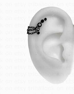 a fake ear with black beads and a crown on it