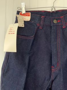 "Rare NWT Vintage Early 80s High Waisted Dark Denim Blue Jeans, by Hush Puppies. New condition and unworn with original tags. Super high rise waist. Front & back pleated down center of leg. Dark denim with red stitching, embroidered back pockets with basset hound logo. Amazing Original condition with original store tags! Brand - Hush Puppies Condition - Original. Deadstock from the 80s, New with original tags 100% Cotton Made in Taiwan Machine Washable Vintage Size - 8 Size - 26\" waist Best High Waist Fitted Jeans With Contrast Stitching, Fitted High Waist Jeans With Contrast Stitching, Retro Fitted Jeans For Streetwear, Fitted Retro Jeans For Streetwear, Retro Straight Leg Bottoms With Contrast Stitching, Fitted Cotton Jeans With Contrast Stitching, Retro Fitted Jeans In Rigid Denim, Retro High Waist Cotton Jeans, Fitted High Rise Reworked Jeans