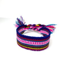 a multicolored bracelet with tassels on it