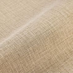 close up view of the fabric textured with natural linen in light brown and neutral colors