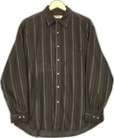 Brown Shirt With Placket In Relaxed Fit, Brown Long Sleeve Shirt With Buttons, Brown Relaxed Fit Shirt With Placket, Classic Yarn-dyed Button-up Shirt, Classic Yarn-dyed Tops With Relaxed Fit, Classic Relaxed Fit Yarn-dyed Shirt, Classic Yarn-dyed Shirt In Relaxed Fit, Casual Brown Shirt With Button Cuffs, Classic Collared Yarn-dyed Shirt