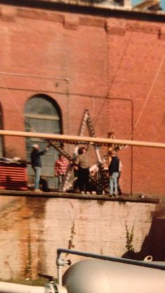 some people are standing on top of a building