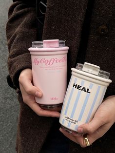 a person holding a cup and a cell phone in their hands with the words heal on it