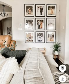 a living room filled with lots of pictures on the wall and furniture in front of it