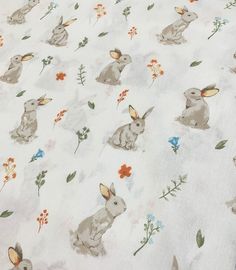 the fabric has rabbits and flowers on it