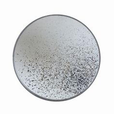 a white plate with black speckles on it