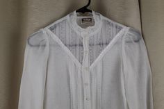 "Rare Childs/Girls white blouse Gunne Sax Jessica's Gunnies Blouse has double layer but single layer on sleeve Lace trim on sleeves and sheer lace insert on blouse with classic Gunne Sax satin ribbon detail We are not great on childs sizes so please use measurements below. We think this is a size 10 Girlss/child Pearl buttons Good condition Missing one button on one cuff See photo #7. Has been sewn closed. Very light fading Hand washed and ready to wear! Measurements Underarm to underarm: 15.5\" Heirloom Dresses, Gunne Sax, Girls Blouse, Lace Insert, Pearl Buttons, White Blouse, Sheer Lace, Satin Ribbon, Double Layer